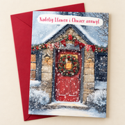 Cerdyn Nadolig Chwaer Annwyl – Drws Coch / Welsh Christmas card with a red door decorated for Christmas, lying flat beside a deep red envelope.