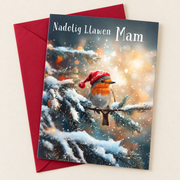 Cerdyn Nadolig Mam – Robin / Welsh Christmas card with a robin in a Christmas hat, lying flat beside a deep red envelope.