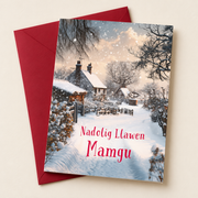 Cerdyn Nadolig Mamgu – Bythynnod Eira / Welsh Christmas card with a lane and cottages in the snow, lying flat beside a deep red envelope.